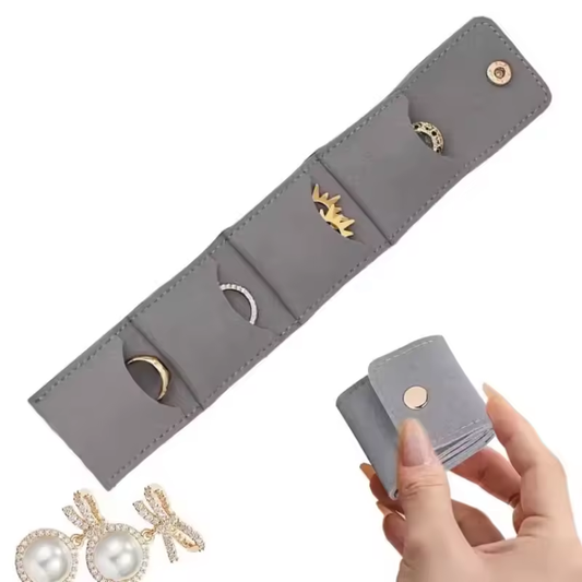 Graue Schmuck-Reisetasche aus Kunstleder – faltbares Schmucketui mit Fächern für Ringe, Ohrringe und Ketten.